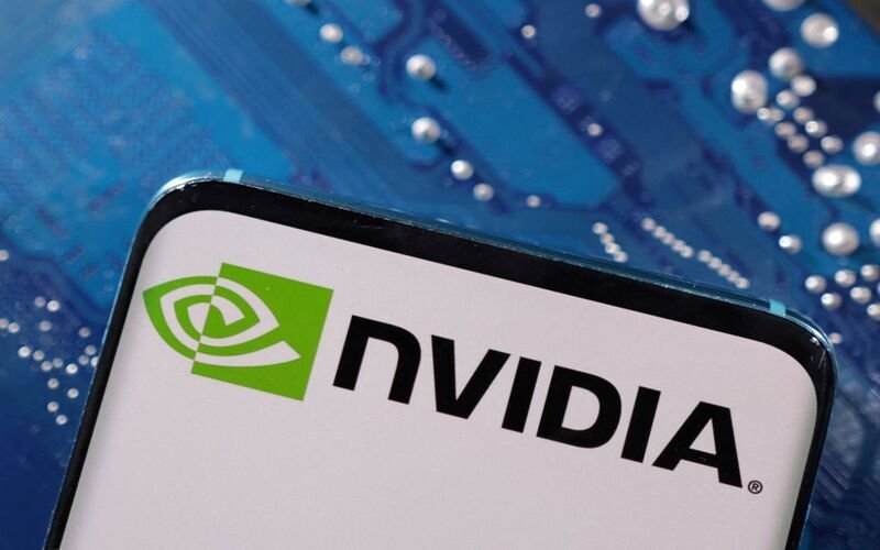 A smartphone with a displayed NVIDIA logo is placed on a computer motherboard in this illustration taken March 6, 2023./Dado Ruvic/Illustration