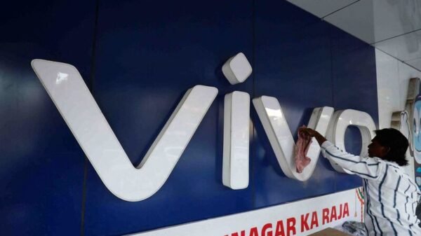 A man cleans the logo of a Chinese smartphone brand Vivo outside a store in Ahmedabad, India, October 10, 2023 REUTERS/Amit Dave/File photo