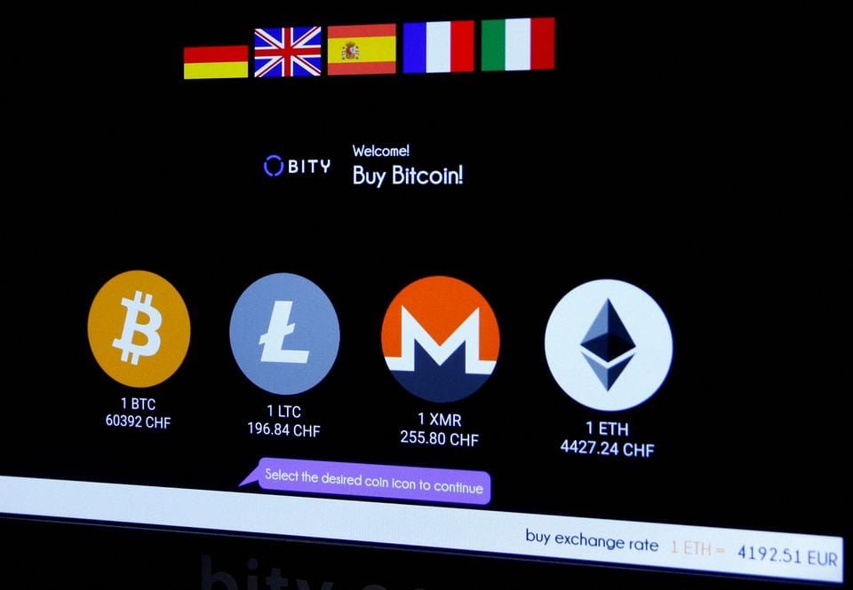The logos and exchange rates of Bitcoin (BTH), Litecoin (LTC), Monero (XMR) and Ether (ETH) to Swiss franc (CHF) are seen on the display of a cryptocurrency ATM of blockchain payment service provider Bity at the House of Satoshi bitcoin and blockchain shop in Zurich, Switzerland November 4, 2021. REUTERS/Arnd Wiegmann/File Photo