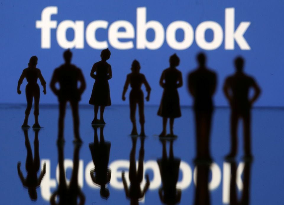 Small toy figures are seen in front of Facebook logo in this illustration picture, April 8, 2019. REUTERS/Dado Ruvic/Illustration