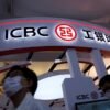 People walk past a booth of ICBC Credit Suisse Asset Management Co at the 2020 China International Fair for Trade in Services (CIFTIS), in Beijing, China September 5, 2020. REUTERS/Tingshu Wang/File photo