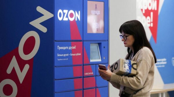 A woman picks up an order at the pick-up point of the Ozon online retailer in Moscow, Russia March 16, 2020. REUTERS/Evgenia Novozhenina/File Photo