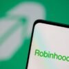 Robinhood logo is seen on a smartphone in front of a displayed same logo in this illustration taken, July 2, 2021. REUTERS/Dado Ruvic/Illustration