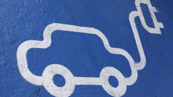 The logo of an electric car is painted on the road during the opening ceremony of the first Latin American public charging station, at Santiago, April 20, 2011. REUTERS/Ivan Alvarado/File photo