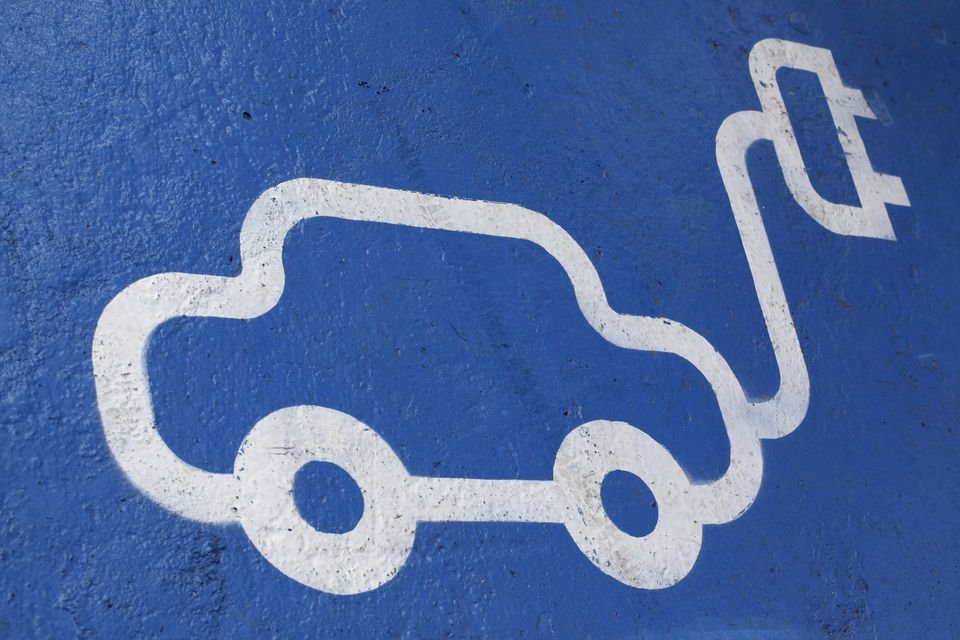 The logo of an electric car is painted on the road during the opening ceremony of the first Latin American public charging station, at Santiago, April 20, 2011. REUTERS/Ivan Alvarado/File photo