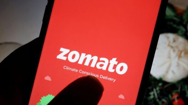 The logo of Indian food delivery company Zomato is seen on its app on a mobile phone displayed in front of its company website in this illustration picture taken July 14, 2021. REUTERS/Florence Lo/Illustration/File Photo