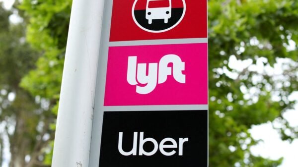 A sign marks a rendezvous location for Lyft and Uber users at San Diego State University in San Diego, California, U.S., May 13, 2020. REUTERS/Mike Blake/File Photo