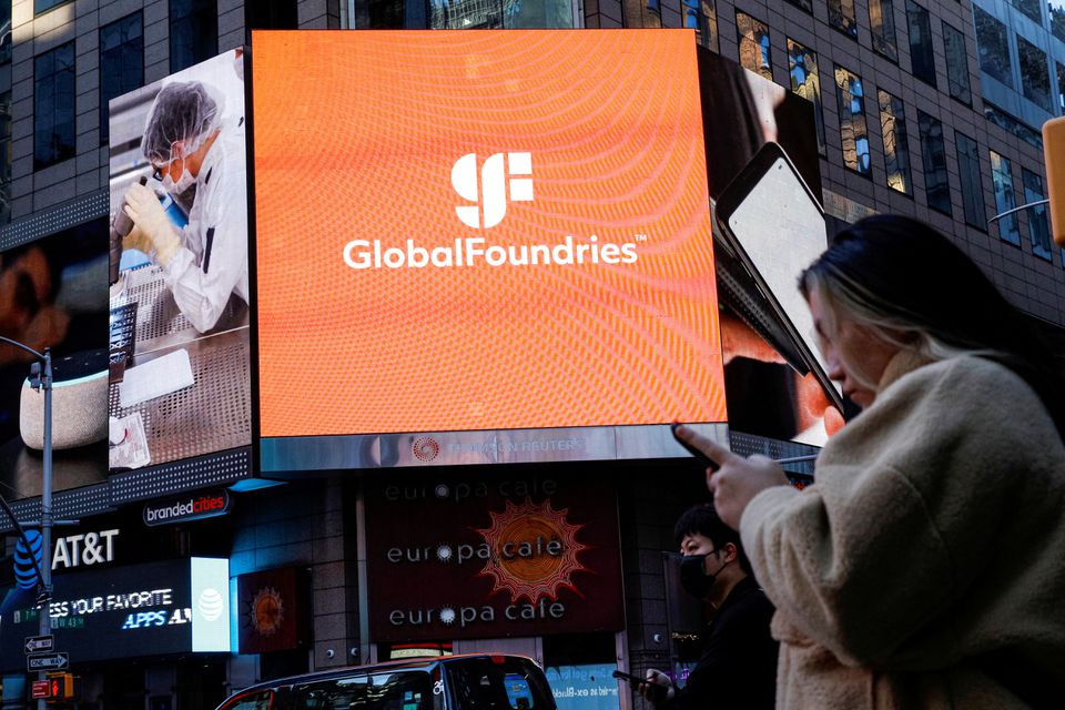 A screen displays the company logo for semiconductor and chipmaker GlobalFoundries Inc. during the company's IPO at the Nasdaq MarketSite in Times Square in New York City, U.S., October 28, 2021. REUTERS/Brendan McDermid/File Photo