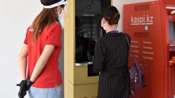 A woman uses a machine patented by the Kazakh company Kaspi.kz in Almaty, Kazakhstan July 29, 2020. REUTERS/Mariya Gordeyeva/File Photo